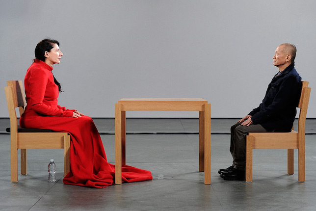 Marina Abramović and Tehching Hsieh during the performance The Artist Is Present, 2018 © MoMA