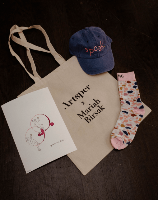 The gift bags from the event, including an original work from Gabrielle Rul and a tote bag featuring artwork by Mariah Birsak